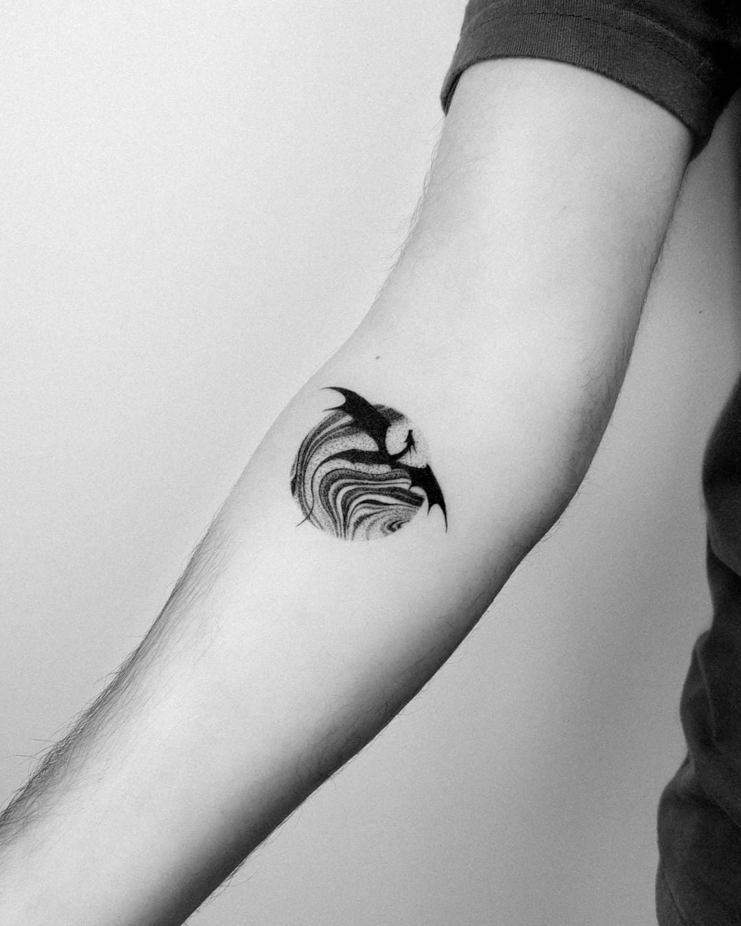 22 Epic Game Of Thrones Tattoos To Obsess over - Body Artifact circle tattoo with dragon flying in front of the moon