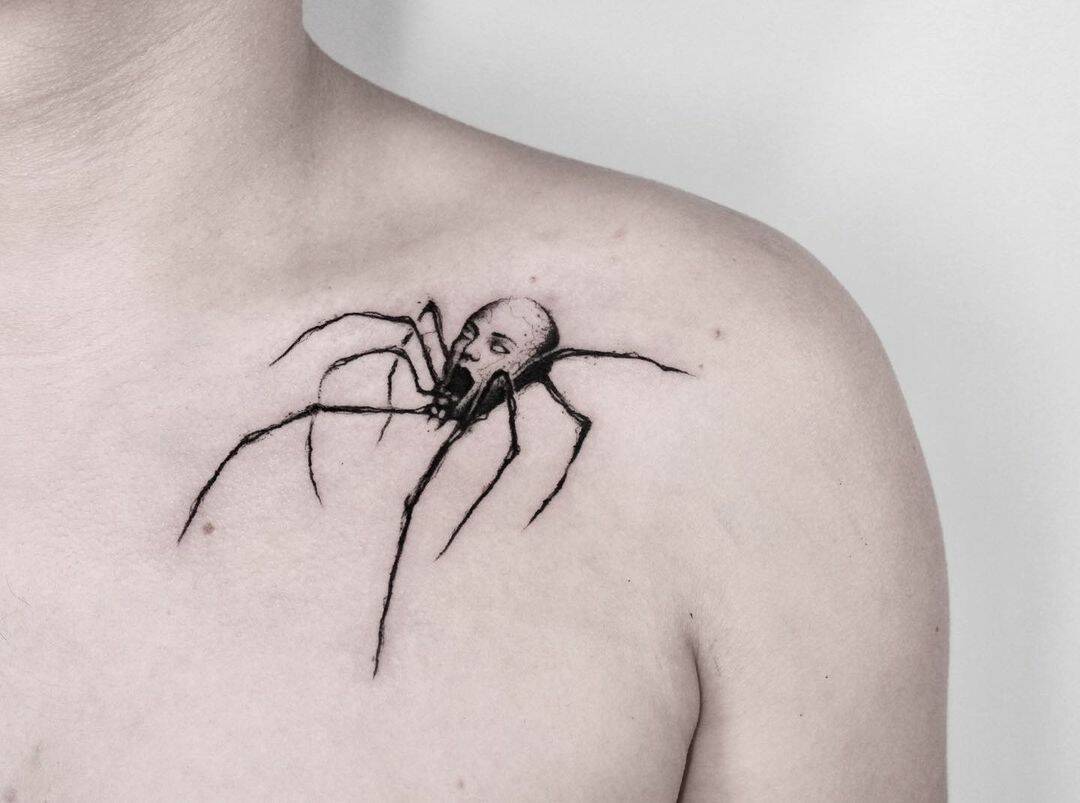 spider tattoo with creepy human head
