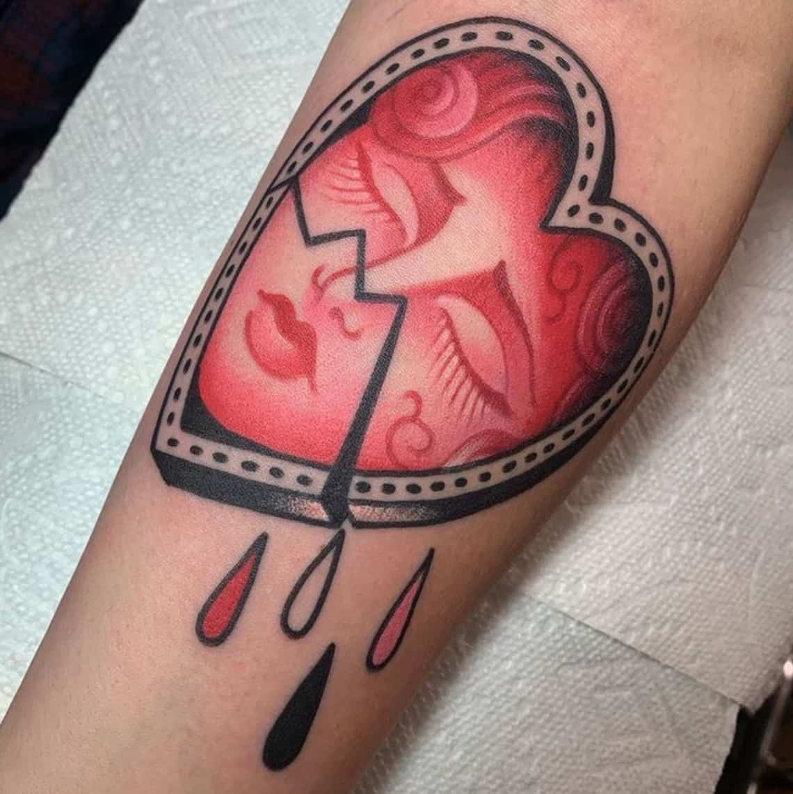 Traditional heart and dagger tattoo