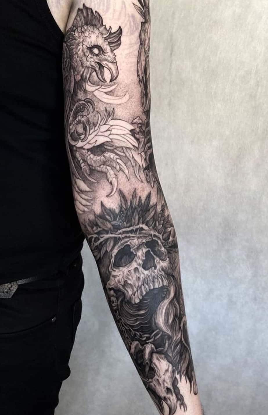 witcher full sleeve tattoo with skull and dragon
