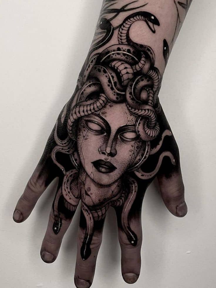 Arm tattoo of Medusa head statue with snakes for hair tattoo idea |  TattoosAI