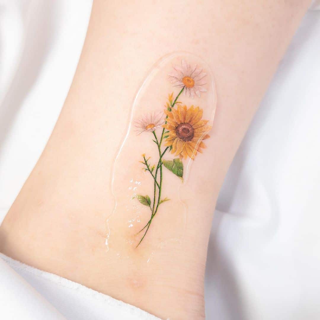 Minimalistic style sunflower tattoo located on the