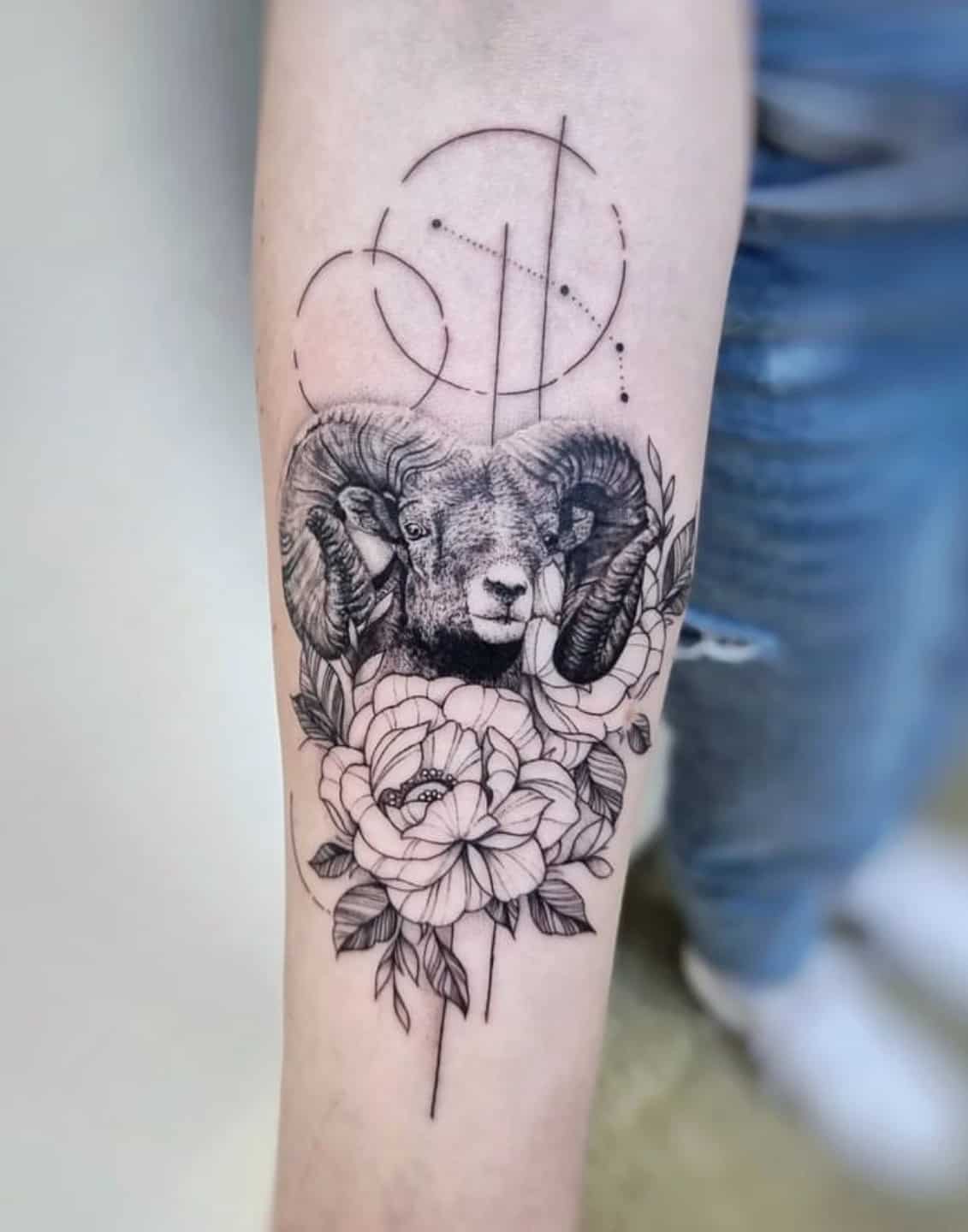 Girl with horns of a ram drawn in tattoo style