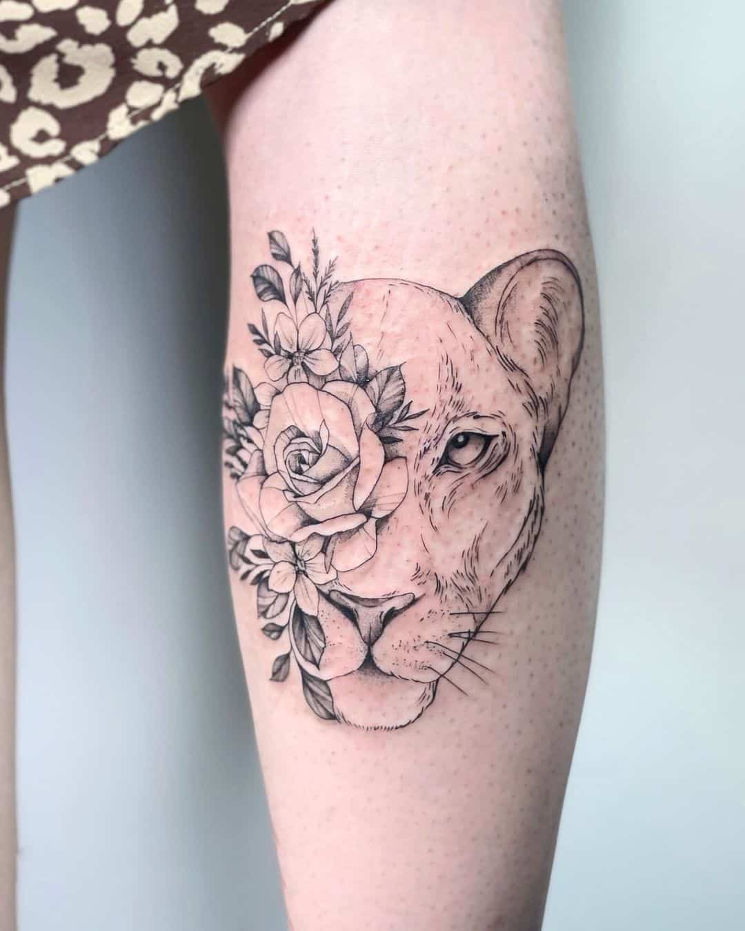 Lioness and flower tattoo