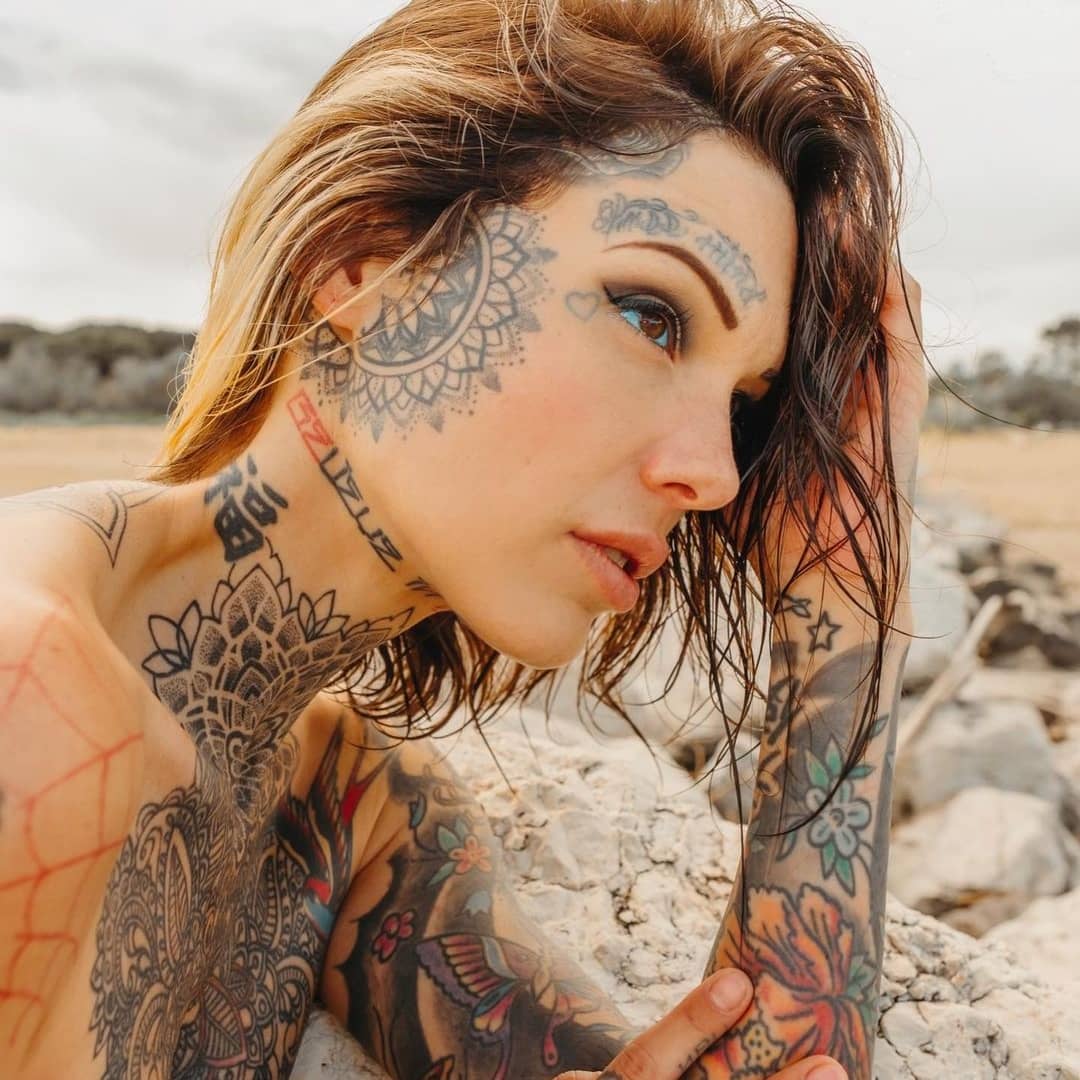 Young woman tattooed face exudes dark creativity generated by AI 24575681  Stock Photo at Vecteezy