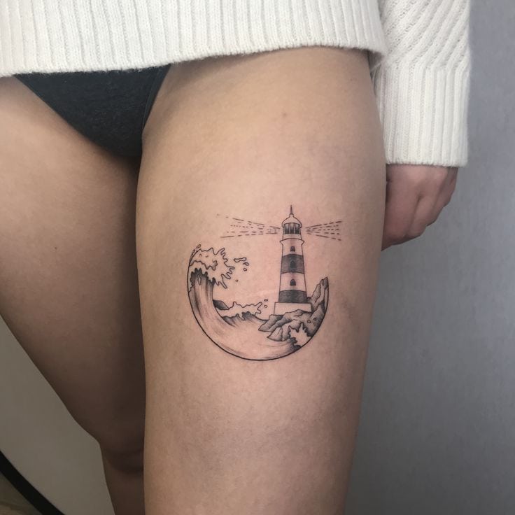 Woman, lighthouse and strawberry tattoos located on the