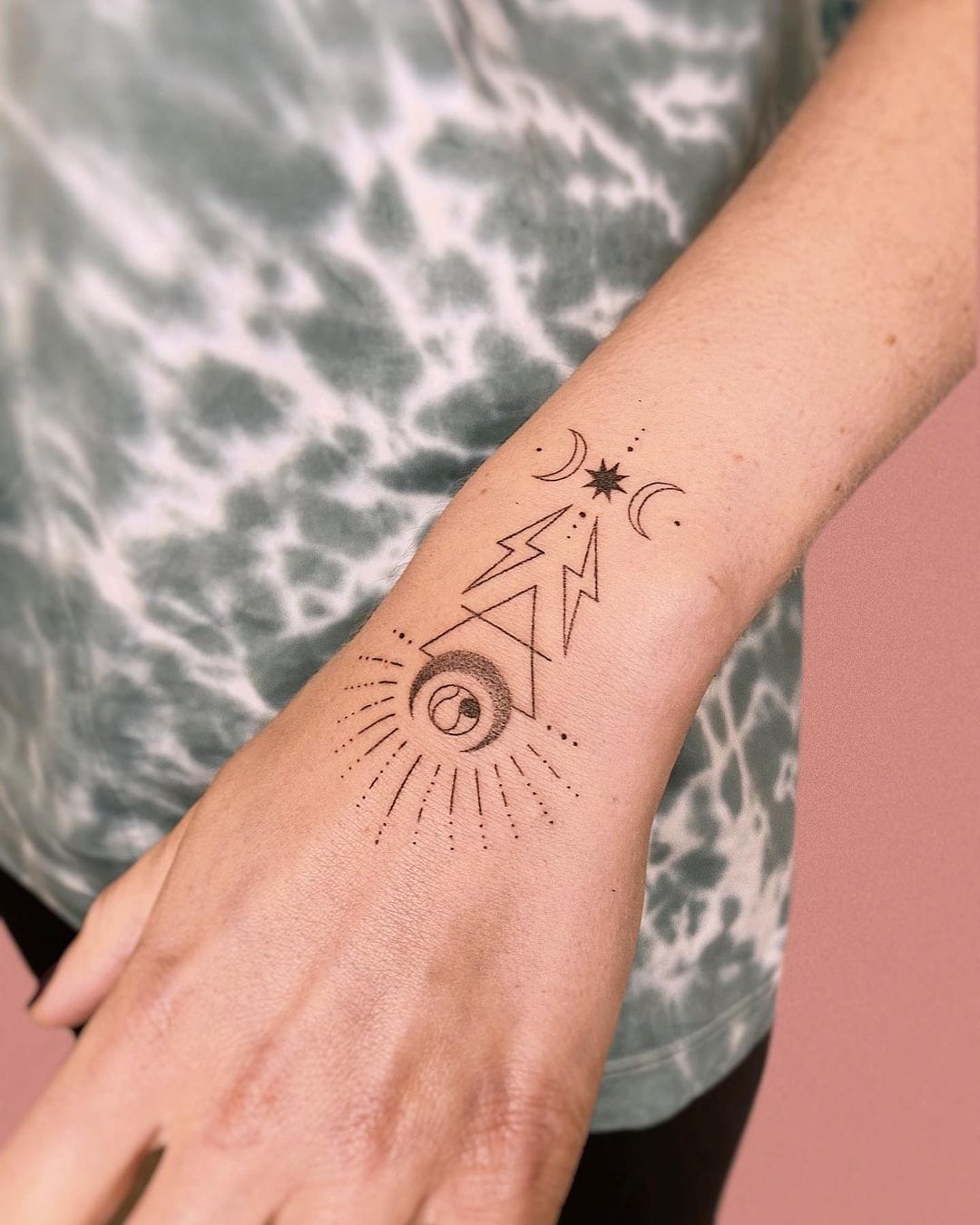 Leo Zodiac symbol tattoo on the inner forearm.