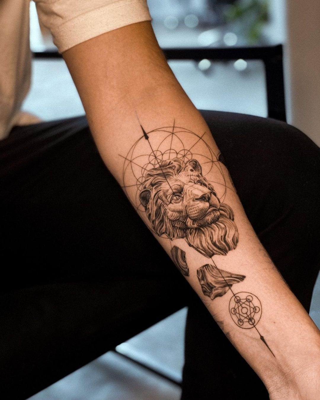 Leo Zodiac symbol tattoo on the left inner wrist.