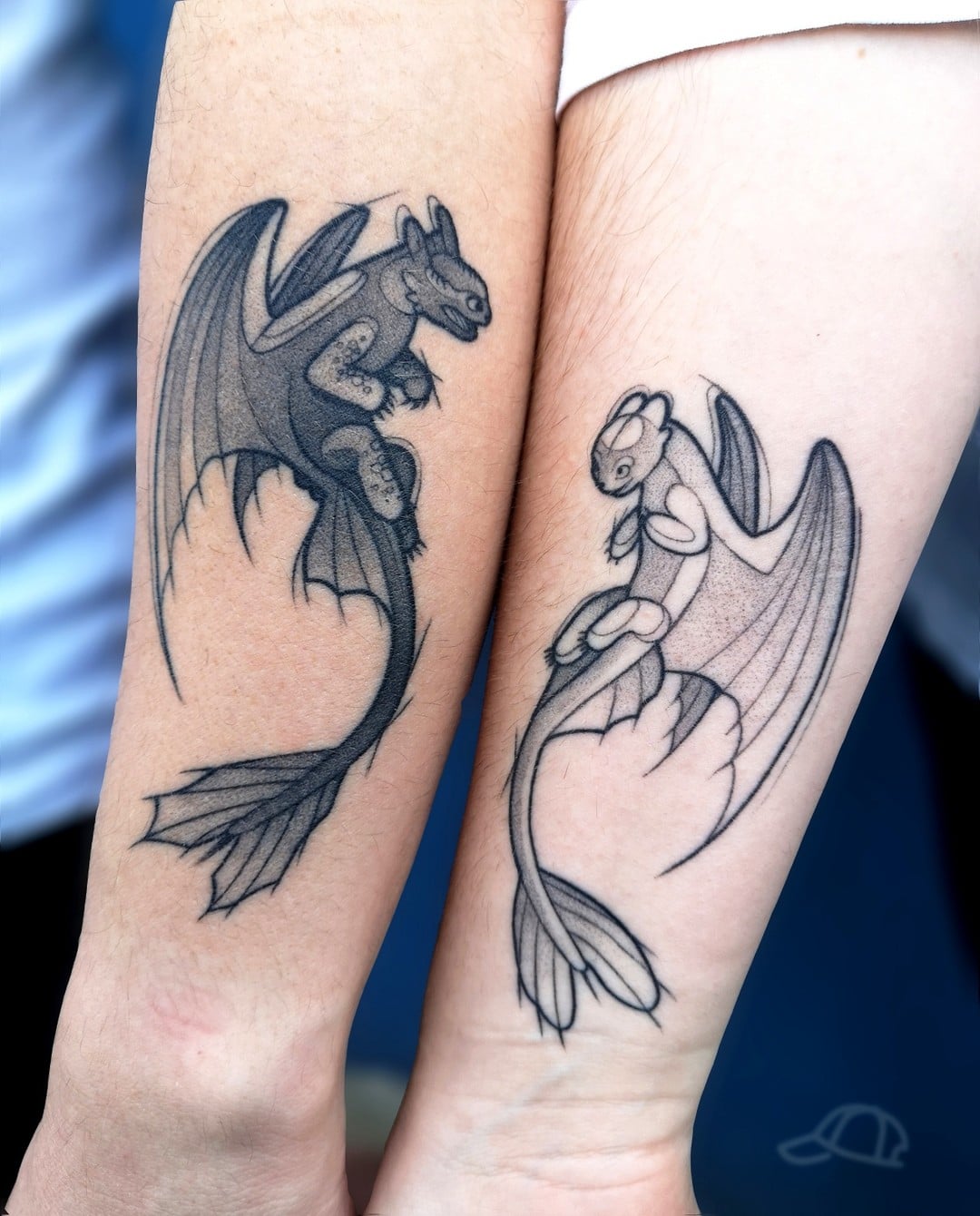 Toothless tattoo located on the upper arm.