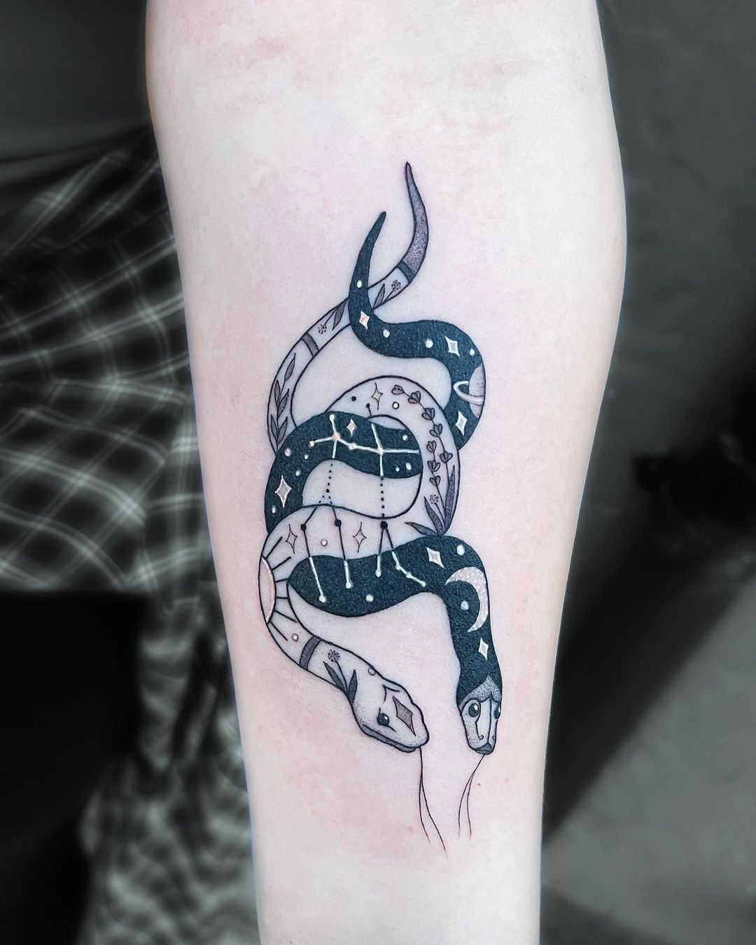 Blue porcelain snake tattoo placed on the tricep.